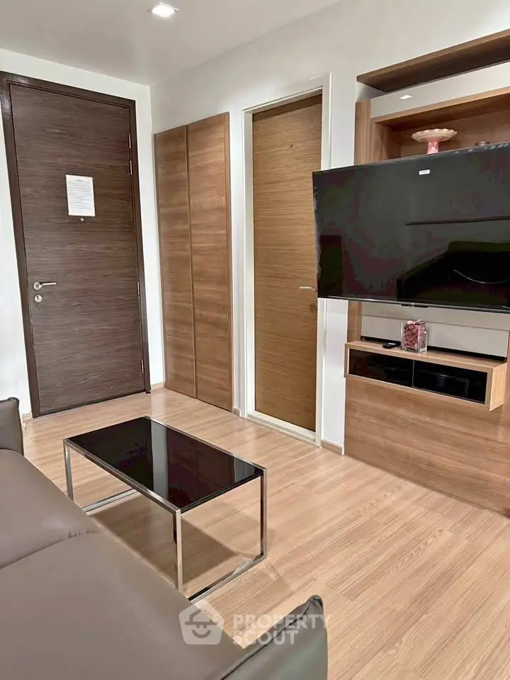 Modern living room with sleek wooden finishes and wall-mounted TV