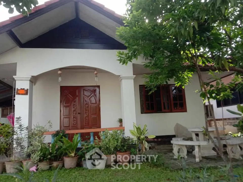 Charming single-story home with lush garden and inviting entrance, perfect for serene living.
