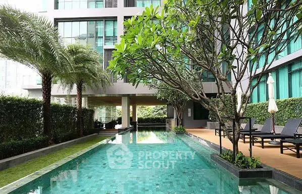 Luxurious condominium with stunning pool and lush greenery, perfect for relaxation and leisure.