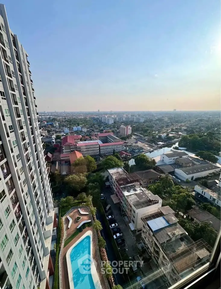 Stunning high-rise apartment view with pool and cityscape, perfect for urban living enthusiasts.
