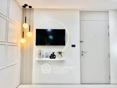 Modern minimalist living room with stylish lighting and wall-mounted TV