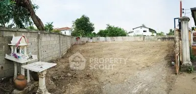 Spacious vacant land plot with boundary walls, ideal for new construction in a serene neighborhood.