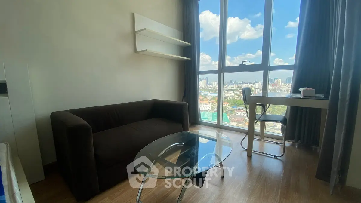 Modern living room with city view, featuring a sleek glass coffee table and cozy sofa.