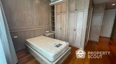 Spacious bedroom with polished hardwood floors and built-in wardrobes, offering a serene and comfortable living space.