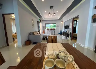 Spacious living room with modern decor and open layout, perfect for family gatherings.