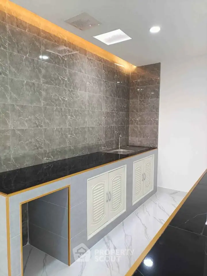 Modern kitchen with sleek marble tiles and elegant cabinetry