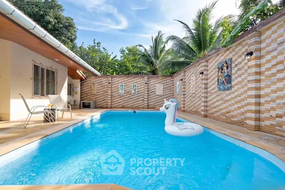 Charming private pool with tropical ambiance and cozy seating area