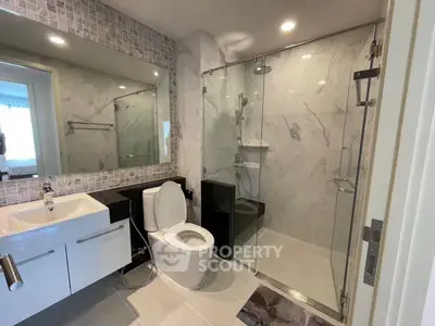 Modern bathroom with glass shower and sleek fixtures