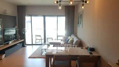 Spacious living room with modern decor and large windows for natural light.