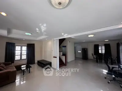 Spacious open-plan living room with modern furniture and ample natural light