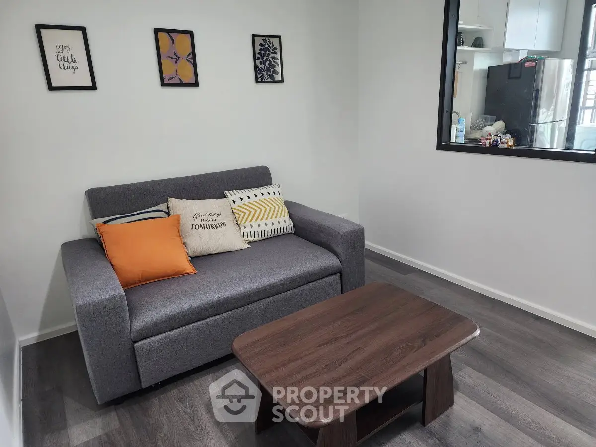 Modern living room with stylish sofa and wooden coffee table, perfect for cozy relaxation.