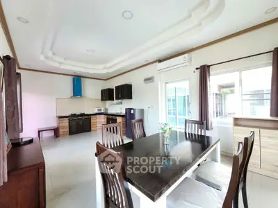 Spacious modern kitchen with dining area and natural light