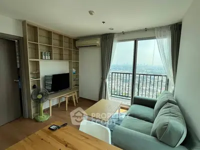 Modern living room with city view, featuring cozy sofa and stylish decor.