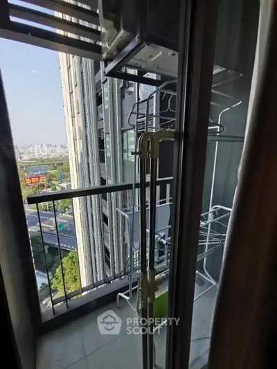 Modern apartment balcony with city view and laundry drying rack