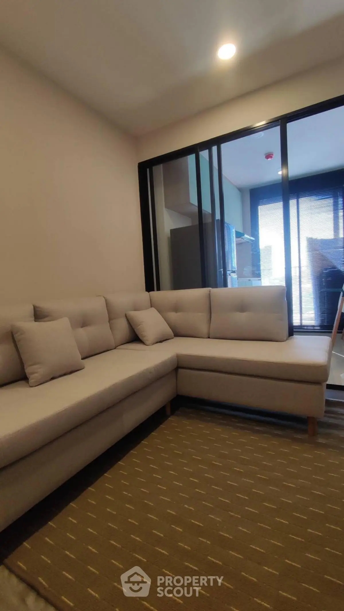 Modern living room with cozy sectional sofa and large window view