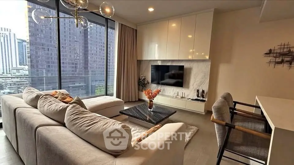 Modern living room with city view, elegant decor, and cozy seating area.