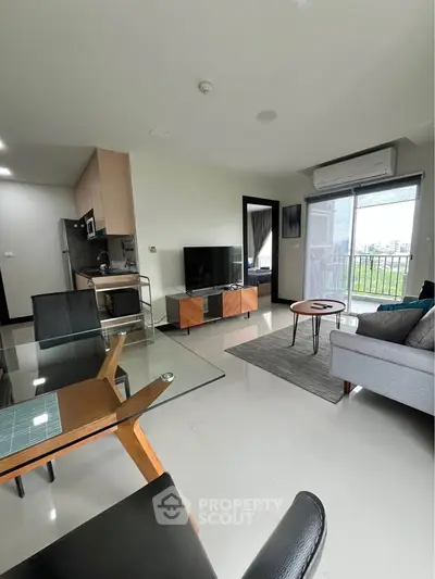 Modern living room with open kitchen and balcony view