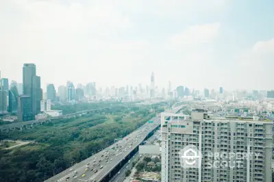 Stunning cityscape view from high-rise apartment overlooking urban skyline and highway