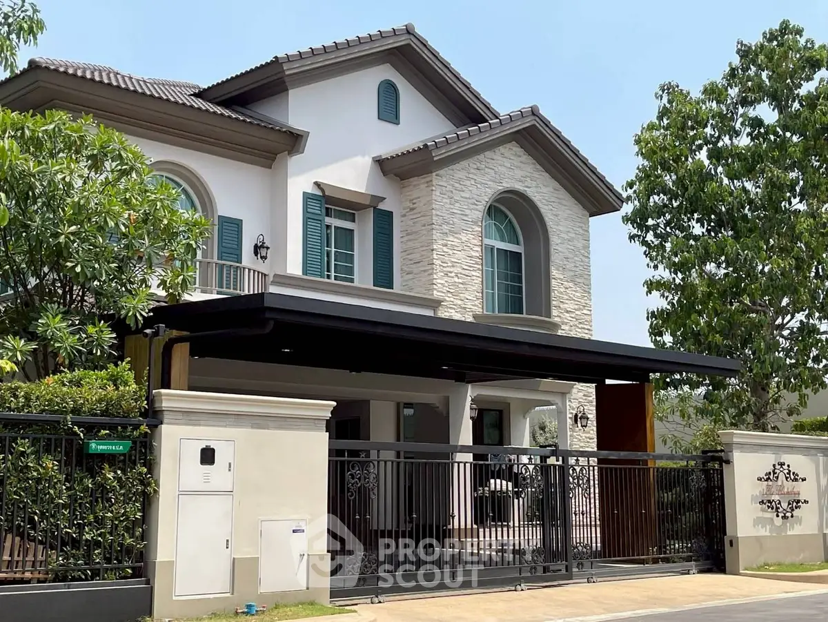 Elegant two-story house with modern facade and lush greenery