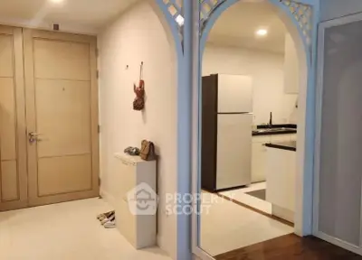 Charming apartment entrance with modern kitchen and stylish decor.