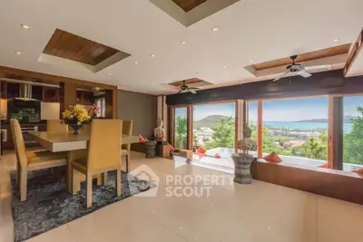 Luxurious open-plan living room with stunning ocean view and elegant dining area.