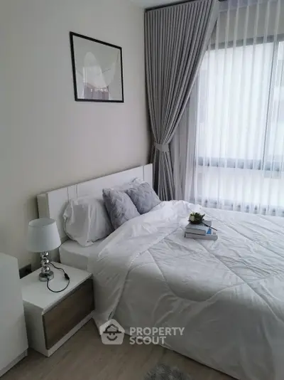 Cozy bedroom with modern decor, featuring a plush bed, elegant curtains, and soft lighting.