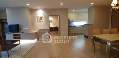 Spacious open-plan living and dining area with modern kitchen in a stylish apartment.