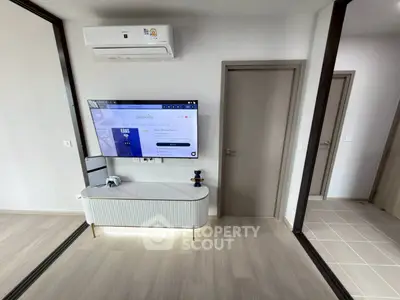 Modern living room with sleek TV setup and air conditioning unit