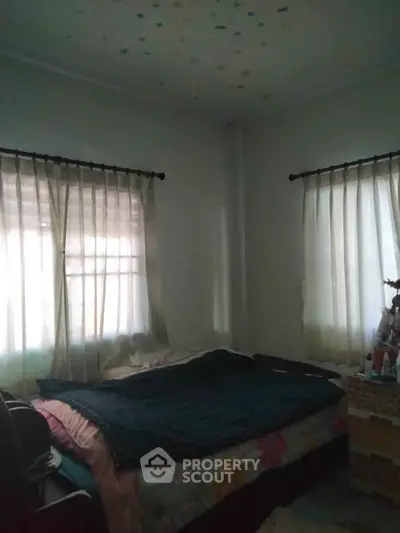 Cozy bedroom with natural light and simple decor