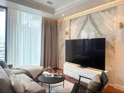 Luxurious living room with marble accent wall and large TV, perfect for modern urban living.