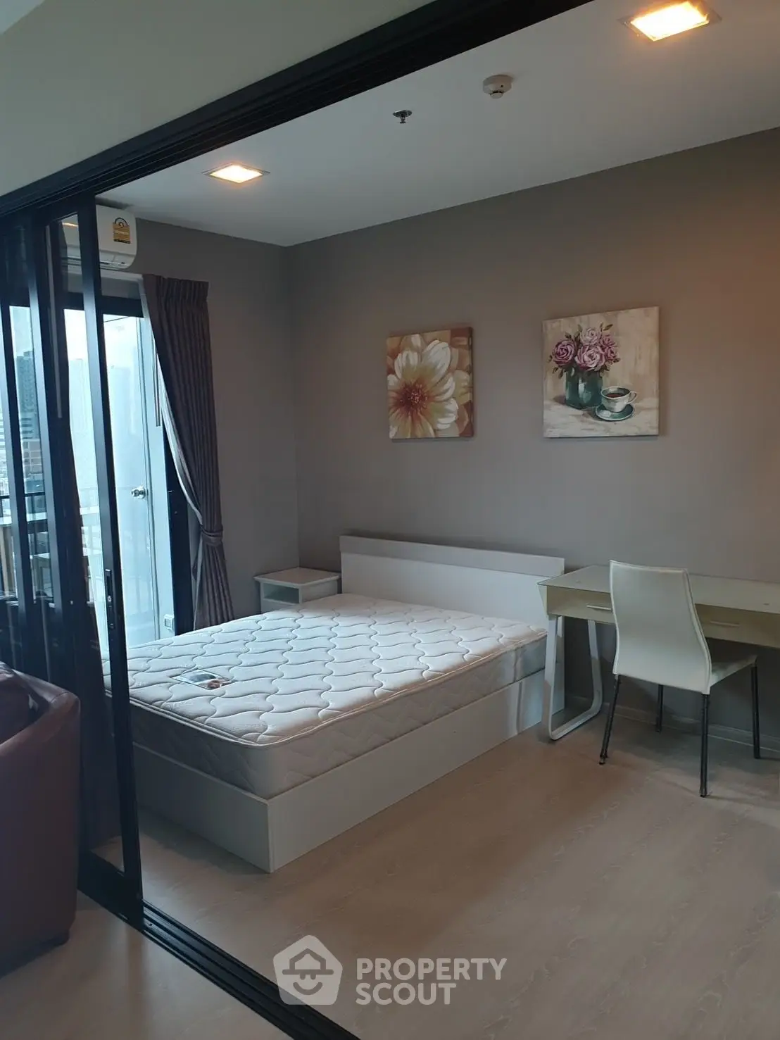 Modern bedroom with balcony access and stylish decor in urban apartment