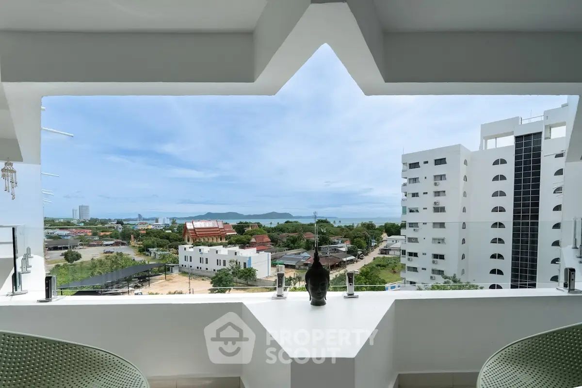 Stunning balcony view with ocean and cityscape, perfect for relaxation and enjoying the scenery.