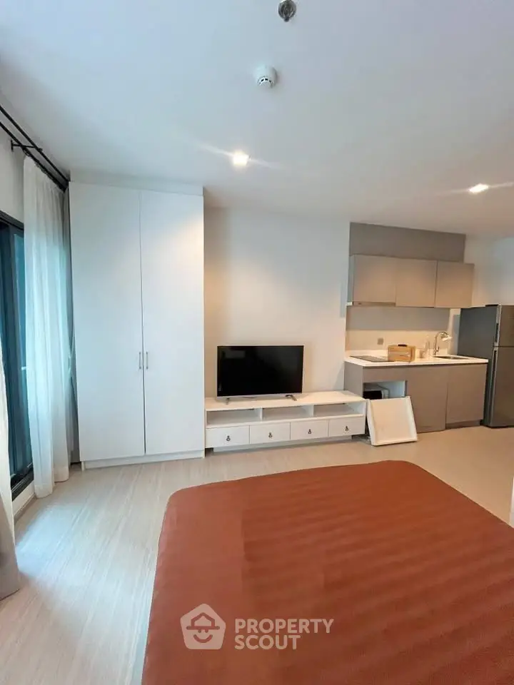 Modern studio apartment with sleek kitchen and cozy living area