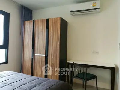 Modern bedroom with sleek wardrobe and air conditioning unit