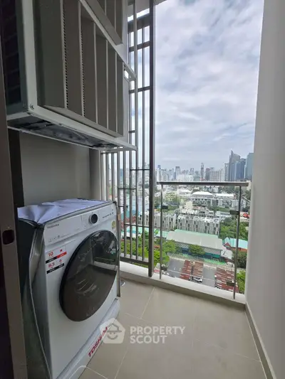 High-rise apartment balcony with washing machine and stunning city view