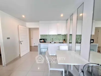 Modern kitchen with sleek white cabinets and stylish dining area