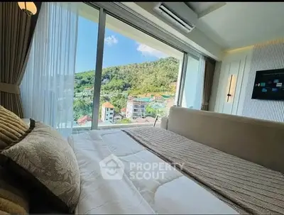 Luxurious bedroom with stunning panoramic view of lush green hills and cityscape.