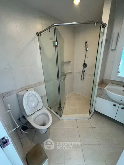 Modern bathroom with glass shower enclosure and sleek fixtures