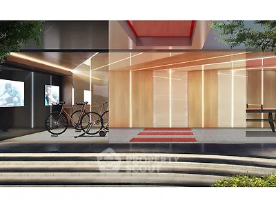 Modern building entrance with sleek design and bicycle parking area.