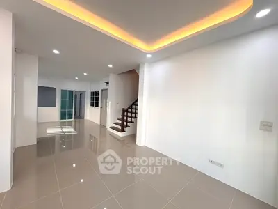 Spacious modern living room with sleek tile flooring and elegant ceiling lighting