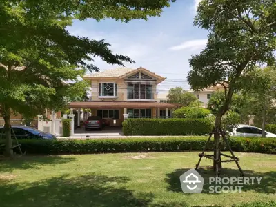 Charming two-story house with lush garden and carport in serene neighborhood