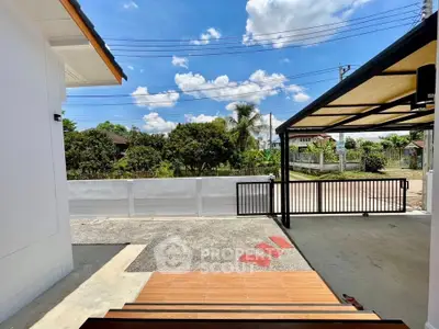 Charming residential exterior with spacious driveway and lush greenery view.