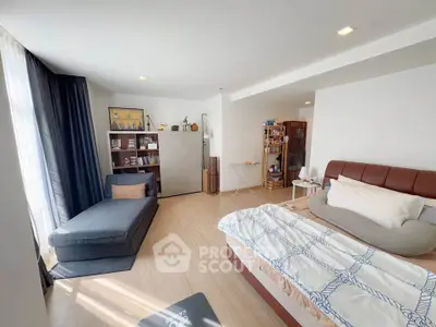 Spacious bedroom with modern decor and ample natural light