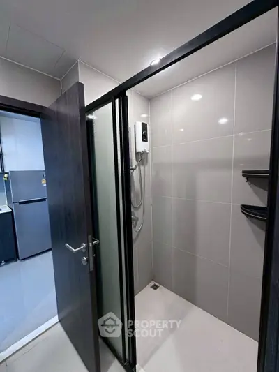 Modern bathroom with sleek shower and dark wood door