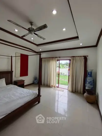 Spacious bedroom with garden view and elegant decor