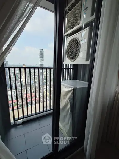 High-rise balcony with city view and air conditioning unit