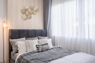 Elegant bedroom with plush bedding and stylish decor in natural light.