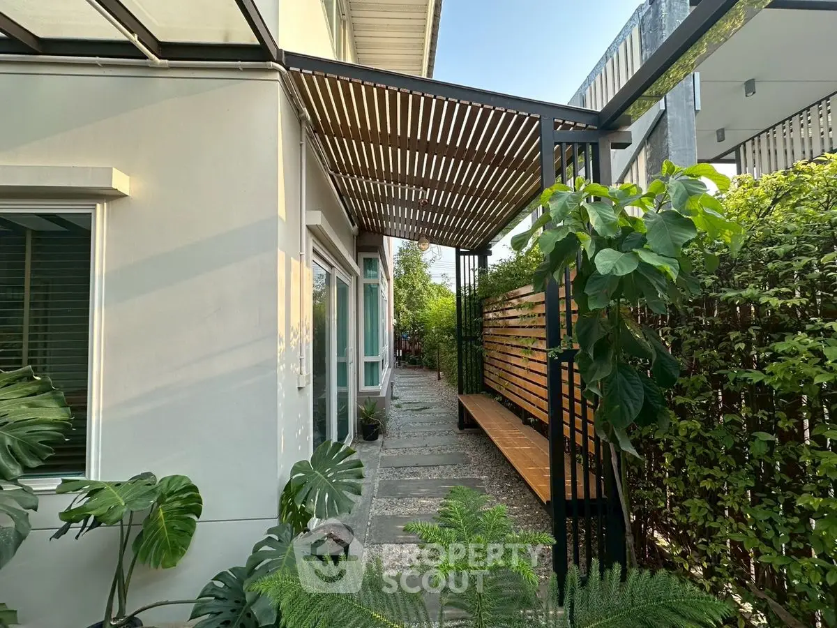 Charming garden walkway with modern pergola and lush greenery