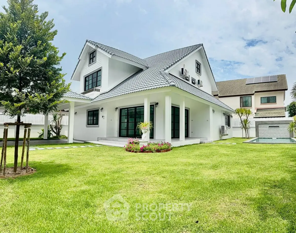 Stunning modern house with lush green lawn and spacious backyard, perfect for family living.