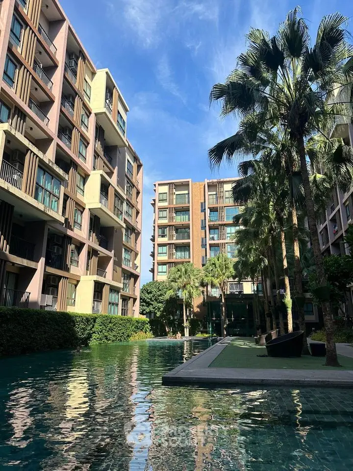 Modern apartment complex with lush landscaping and serene pool view